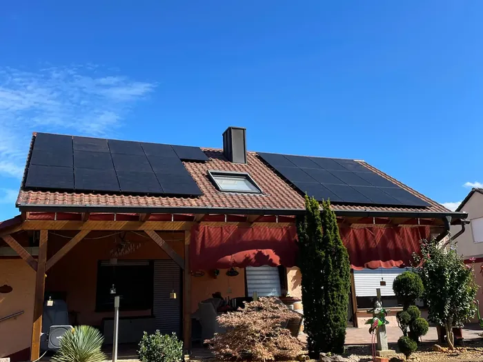 Haus mit Gauben und Photovoltaik auf mehreren Dachflächen